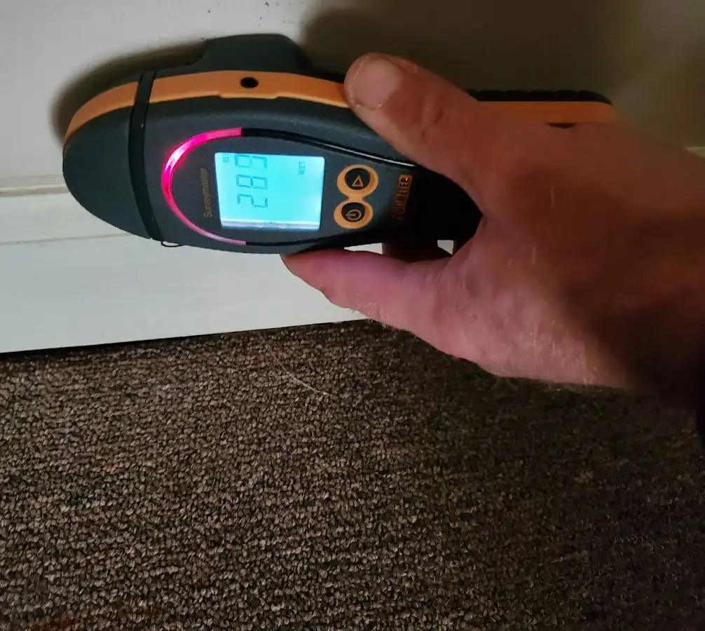 Moisture detection at baseboard during Storm Damage Restoration in Pineville